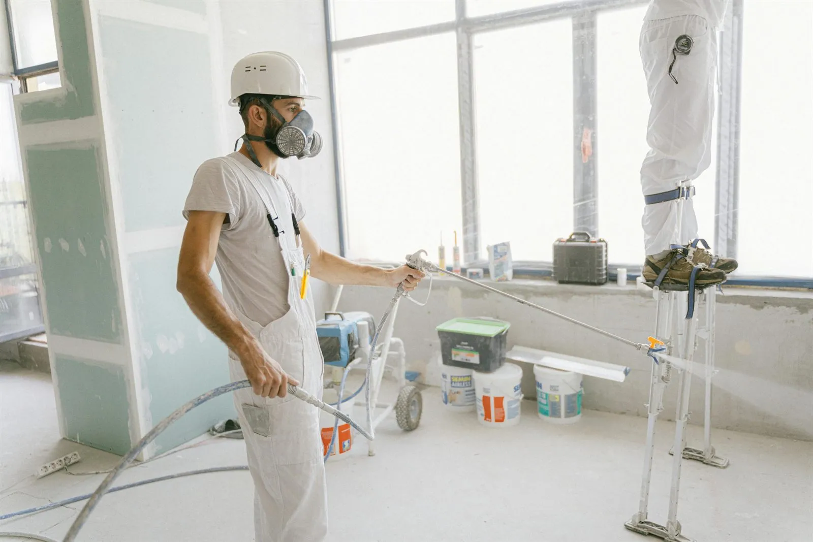 Interior room prepared for painting with covered floors and clean wall lines